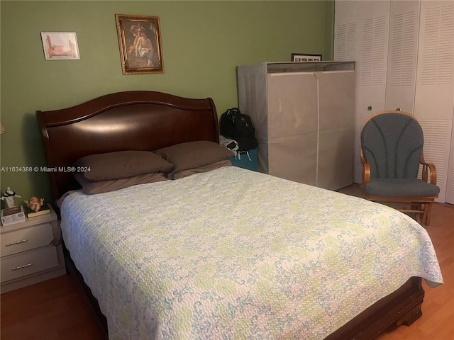 bedroom with a closet and hardwood / wood-style flooring