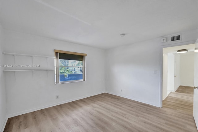 unfurnished room with light hardwood / wood-style floors