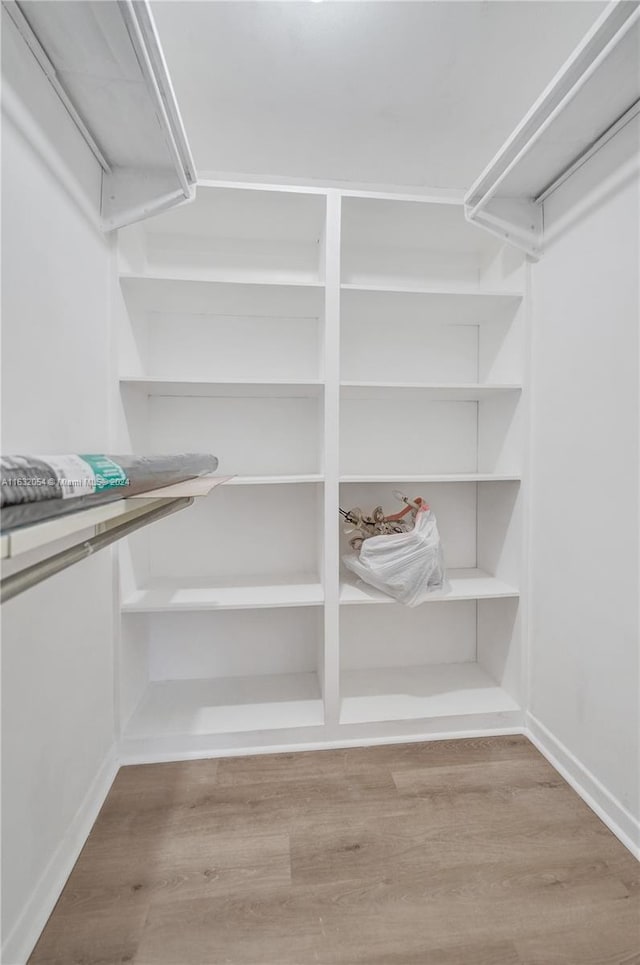 walk in closet featuring hardwood / wood-style flooring