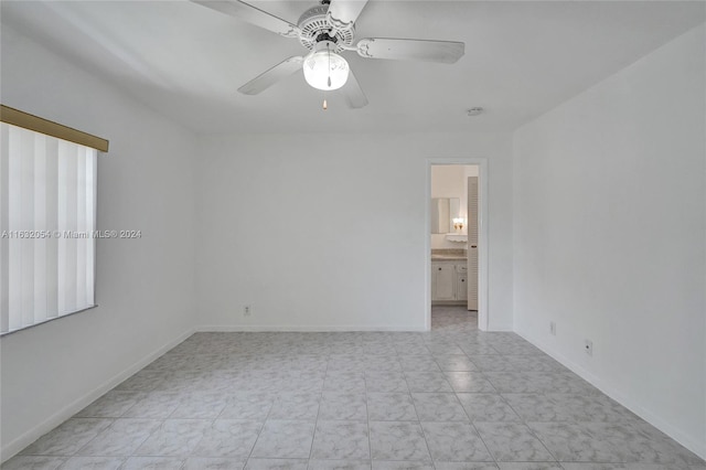 unfurnished room featuring light tile patterned floors and ceiling fan