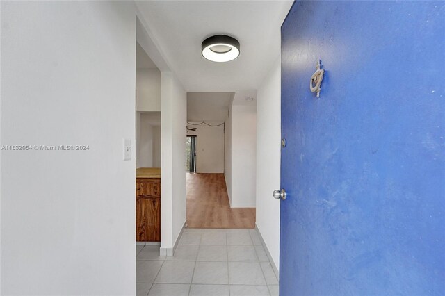 hallway featuring light tile patterned floors