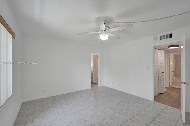 empty room featuring light tile patterned floors and ceiling fan