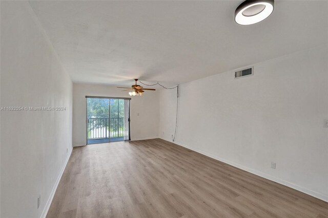 spare room with hardwood / wood-style flooring and ceiling fan