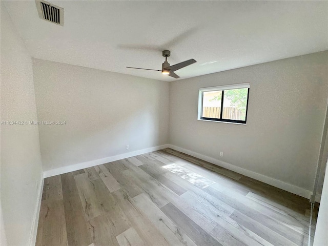 spare room featuring ceiling fan and light hardwood / wood-style floors