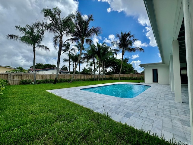 view of pool with a yard and a patio area