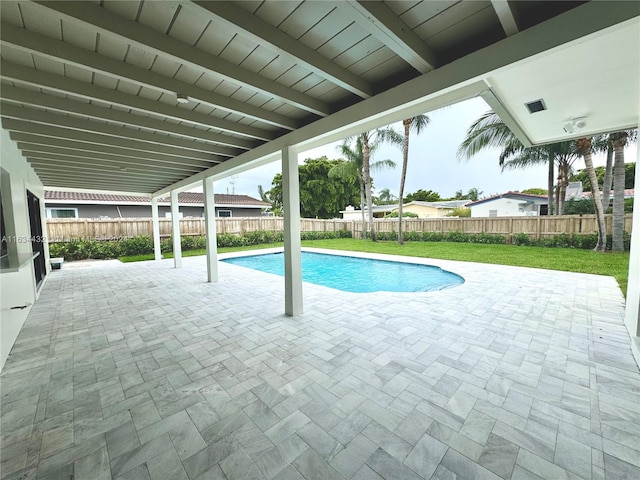 view of swimming pool featuring a patio and a yard