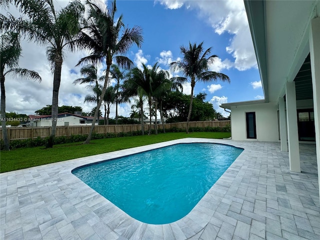 view of swimming pool with a patio and a lawn