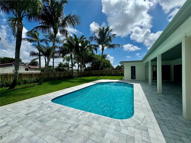 view of swimming pool featuring a lawn and a patio area