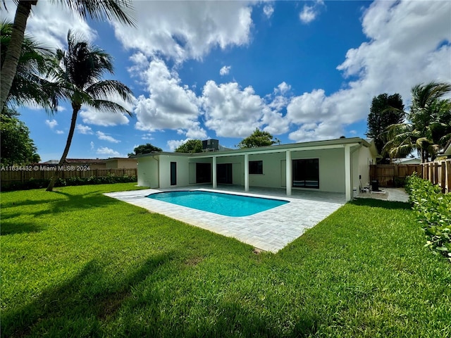 view of swimming pool featuring a yard and a patio area