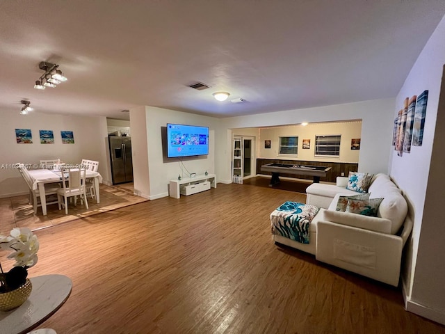 living room with hardwood / wood-style floors and pool table