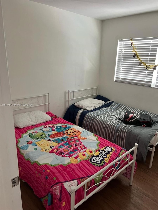 bedroom with dark hardwood / wood-style floors