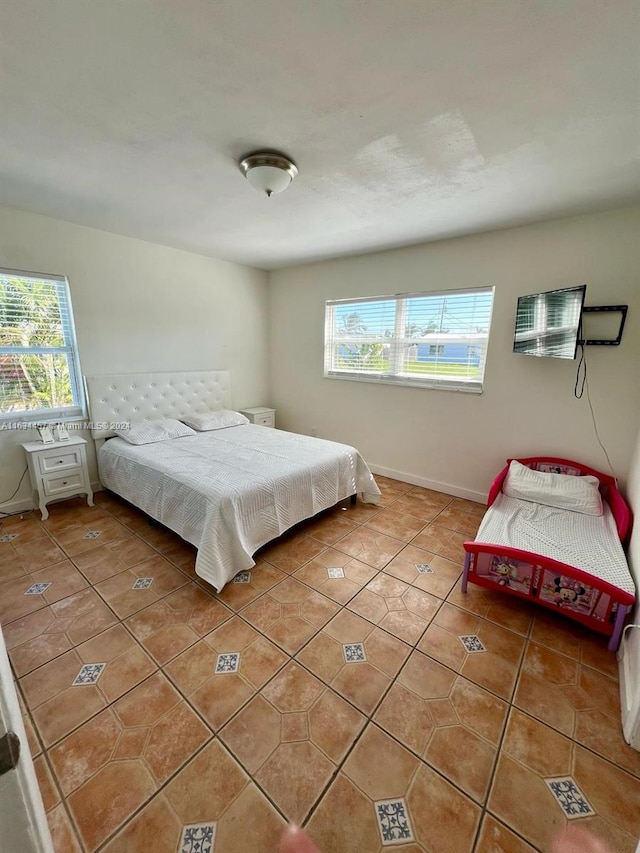 tiled bedroom featuring multiple windows