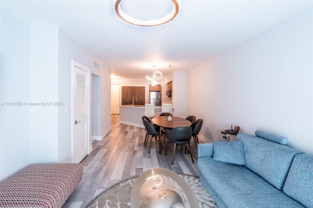 dining room with sink and hardwood / wood-style floors