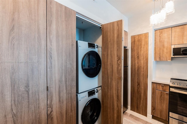 laundry room featuring stacked washer / dryer