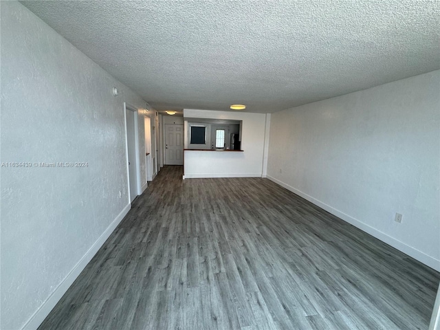 unfurnished living room with hardwood / wood-style floors and a textured ceiling