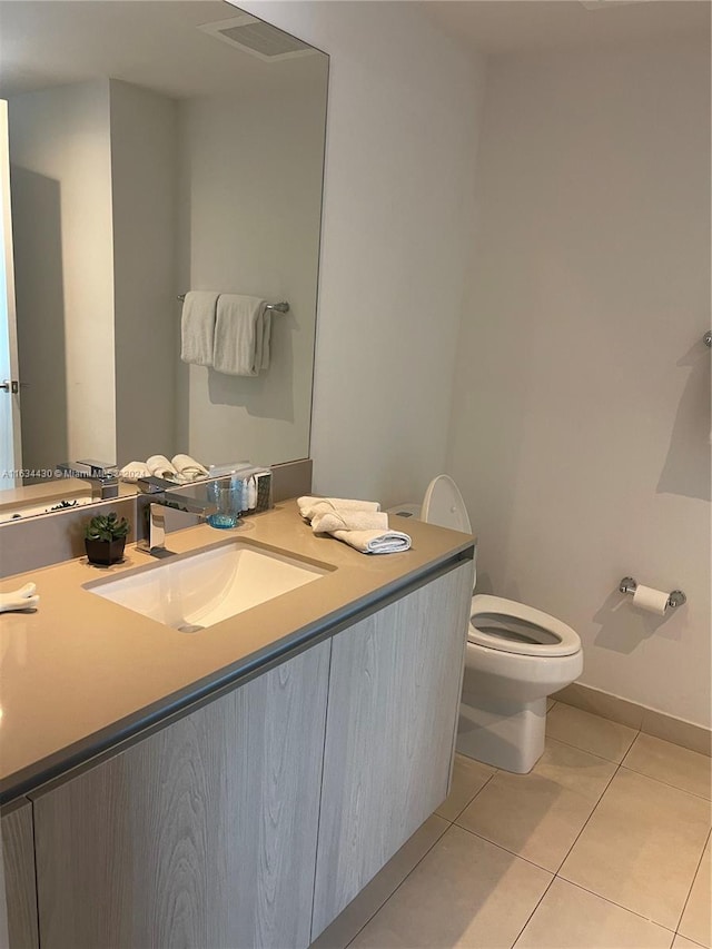 bathroom featuring vanity, toilet, and tile patterned floors