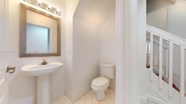 bathroom featuring toilet and tile patterned flooring