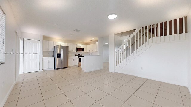 unfurnished living room with light tile patterned flooring