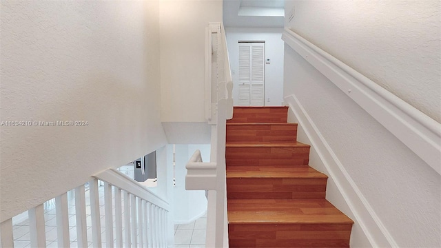 stairway with hardwood / wood-style flooring