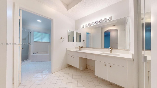 bathroom with shower with separate bathtub, tile patterned floors, a textured ceiling, and dual bowl vanity