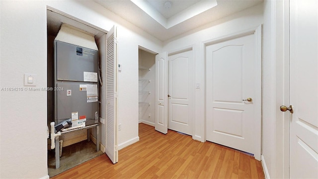 hall with heating unit and light wood-type flooring