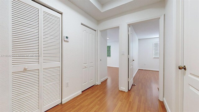 hall with light hardwood / wood-style flooring