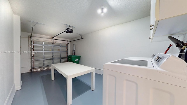 garage with a garage door opener and washer and clothes dryer