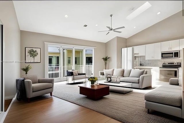 living room featuring high vaulted ceiling, a ceiling fan, and wood finished floors