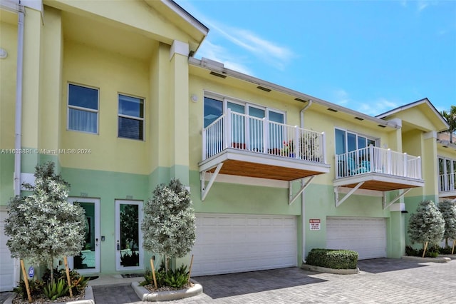 view of front of home featuring a balcony and a garage