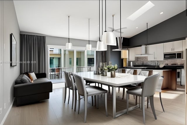 dining area with high vaulted ceiling