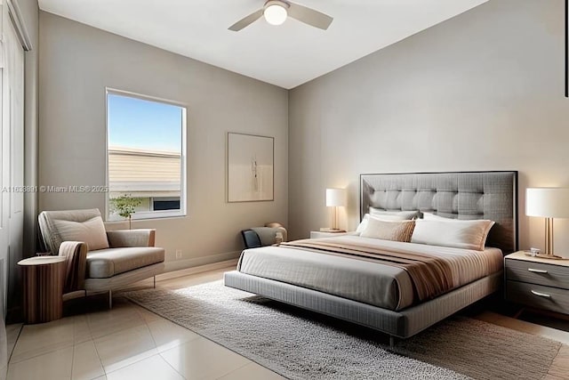 bedroom featuring ceiling fan, lofted ceiling, and light tile patterned flooring