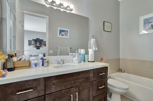 bathroom featuring vanity, a tub, and toilet