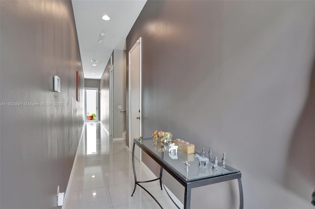 hallway with light tile patterned floors, recessed lighting, and baseboards