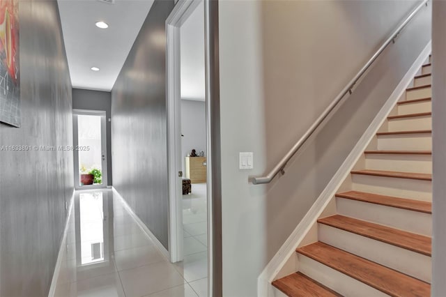 stairs with tile patterned floors and recessed lighting