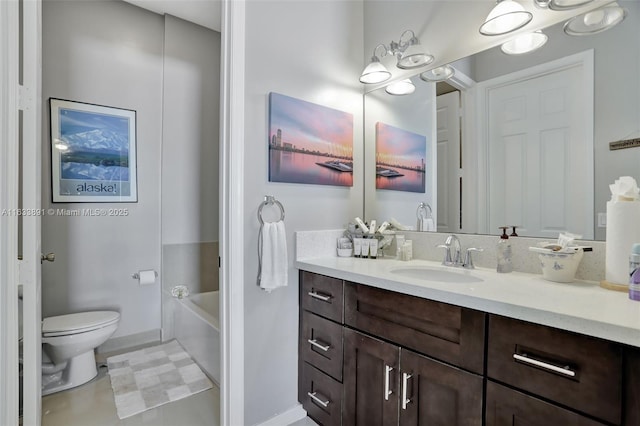 bathroom with toilet, vanity, and a bath