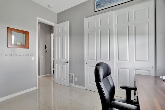 office area with light tile patterned flooring, visible vents, and baseboards