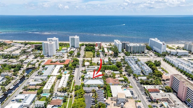 birds eye view of property featuring a city view and a water view