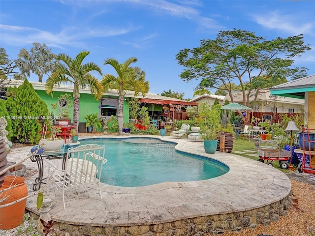 view of swimming pool with a patio area