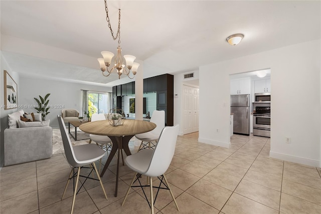 tiled dining room featuring a notable chandelier