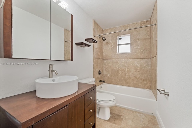 full bathroom featuring toilet, vanity, and tiled shower / bath