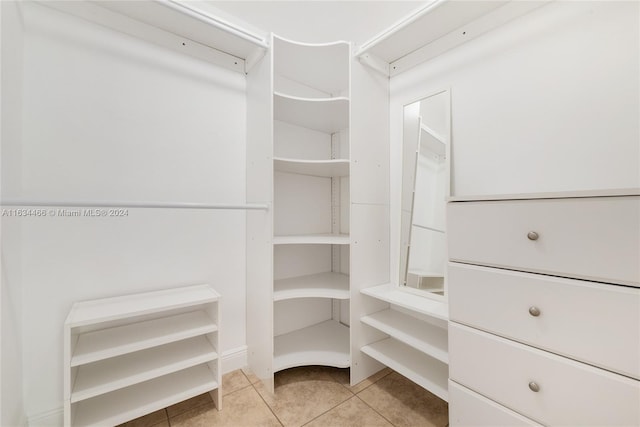 spacious closet featuring light tile patterned floors