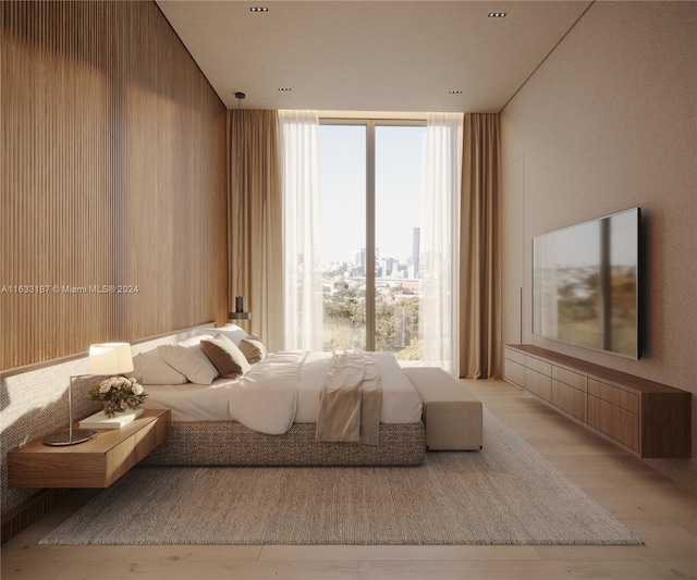 unfurnished bedroom with light wood-type flooring and a wall of windows