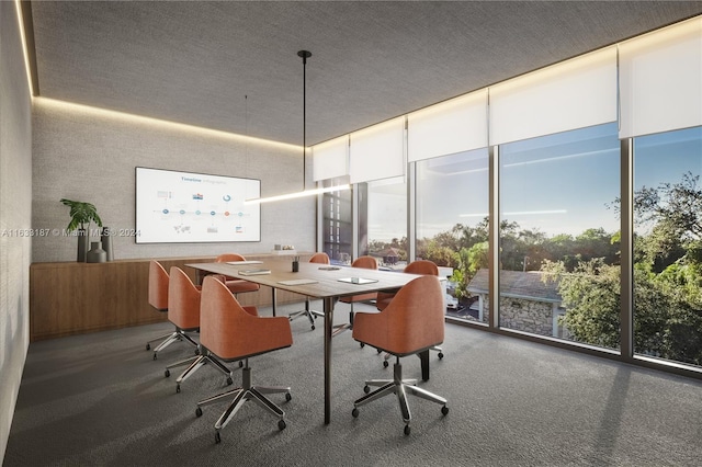 carpeted dining room with a textured ceiling and floor to ceiling windows