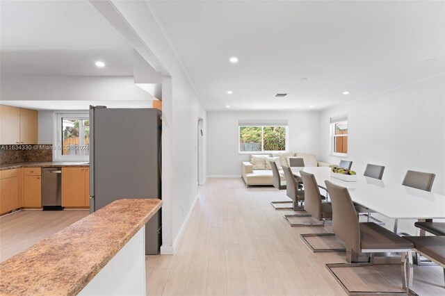 dining space with light wood-type flooring