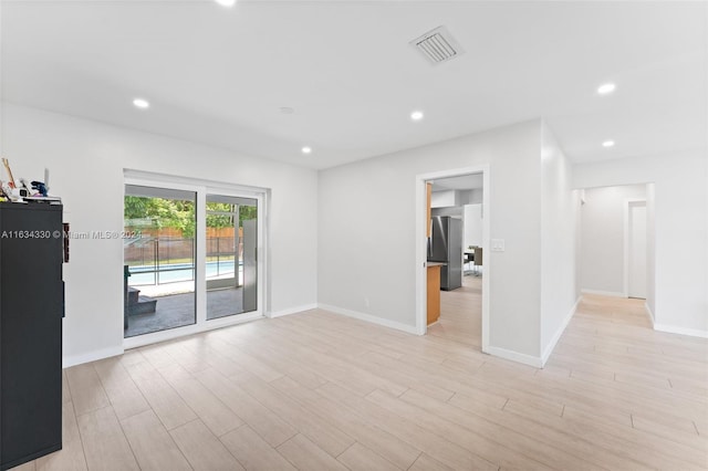 empty room with light hardwood / wood-style floors