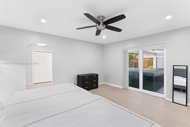 bedroom featuring a closet, access to outside, ceiling fan, and light wood-type flooring