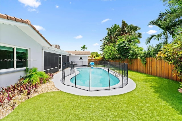 view of swimming pool with a sunroom and a lawn