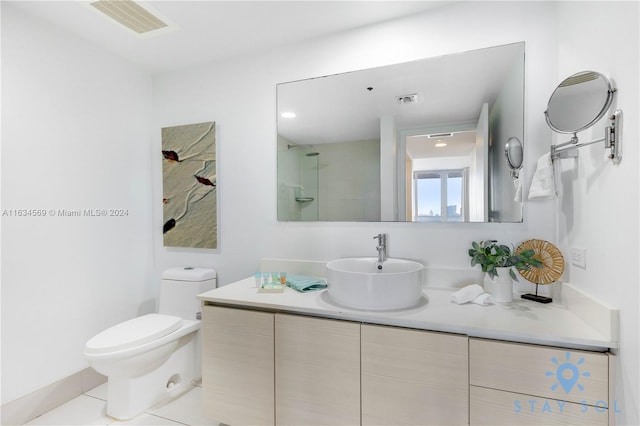 bathroom with vanity, tile patterned flooring, and toilet