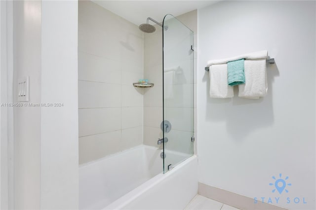 bathroom with tiled shower / bath and tile patterned flooring