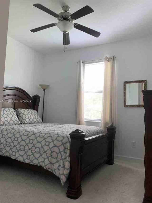 bedroom with light carpet and ceiling fan